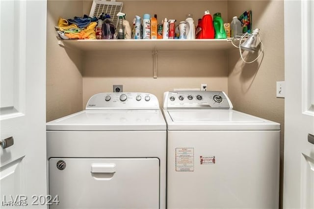 clothes washing area featuring laundry area and washer and clothes dryer