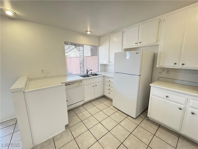 kitchen with white cabinets, white appliances, light countertops, and a sink