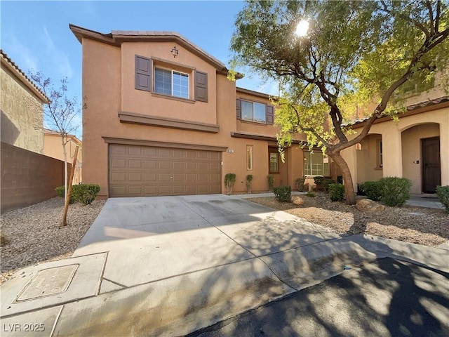 view of front of home with driveway, an attached garage, a tile roof, and stucco siding