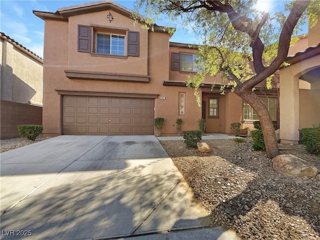 view of front of house featuring a garage, concrete driveway, a tile roof, and stucco siding