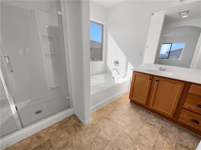 full bathroom with a stall shower, visible vents, a garden tub, and vanity