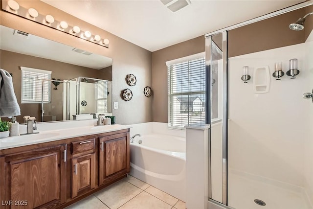 bathroom featuring a garden tub, double vanity, a stall shower, a sink, and tile patterned flooring