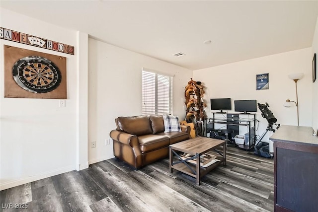 living room with dark wood-style floors, visible vents, and baseboards