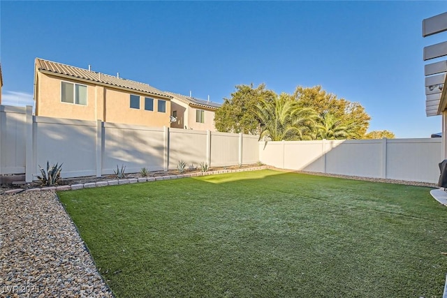 view of yard with a fenced backyard