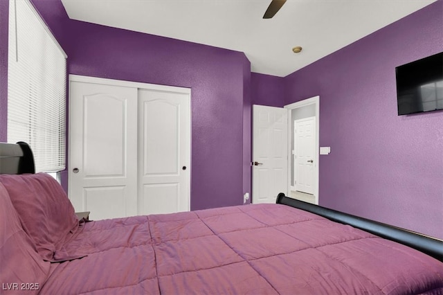 unfurnished bedroom with a ceiling fan, a closet, and a textured wall