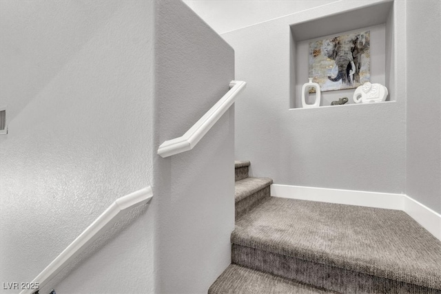 stairs with carpet and baseboards