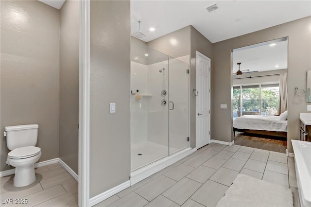 bathroom featuring toilet, visible vents, baseboards, a shower stall, and ensuite bath