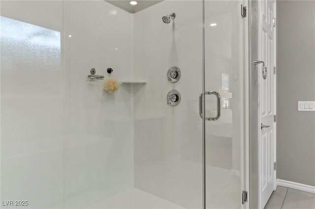 full bathroom featuring a stall shower and baseboards