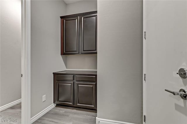 interior space featuring light wood-type flooring and baseboards