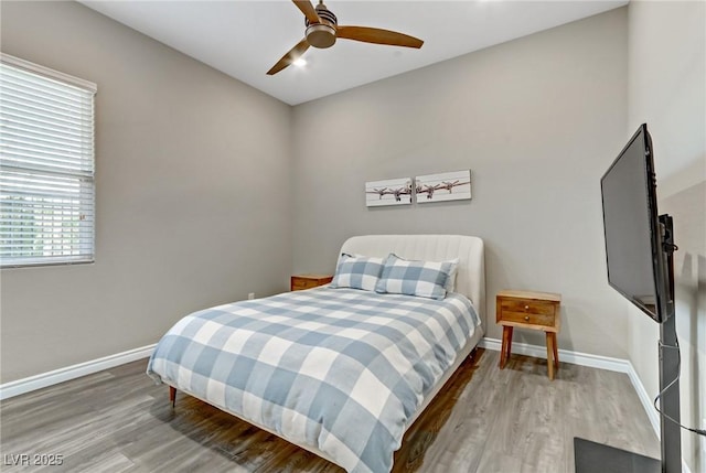 bedroom featuring ceiling fan, wood finished floors, and baseboards