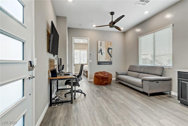 office area with light wood-style flooring, recessed lighting, visible vents, a ceiling fan, and baseboards