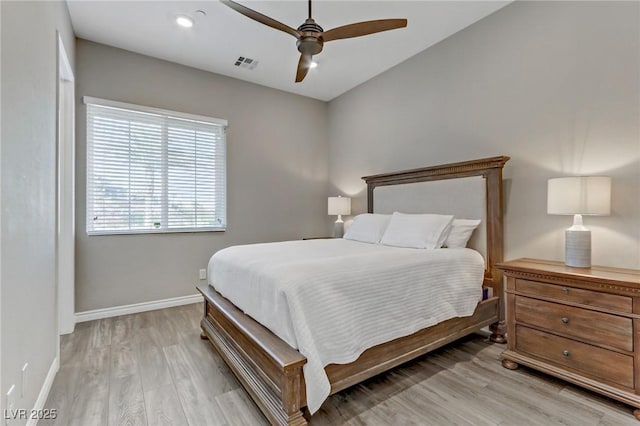 bedroom featuring a ceiling fan, light wood-type flooring, visible vents, and baseboards