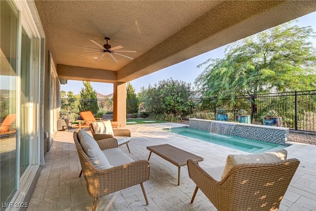 view of swimming pool featuring a patio area, a fenced backyard, an outdoor living space, and a ceiling fan