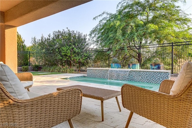 view of swimming pool with a patio area, a fenced backyard, and a fenced in pool