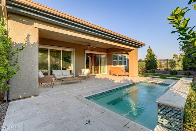 rear view of house featuring a fenced in pool, a ceiling fan, a patio area, fence, and an outdoor living space