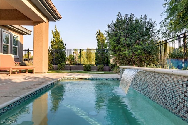 view of swimming pool with a fenced in pool, a fenced backyard, and a patio