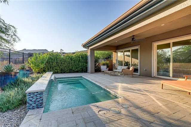 view of pool featuring a patio area, a fenced backyard, a ceiling fan, and a fenced in pool