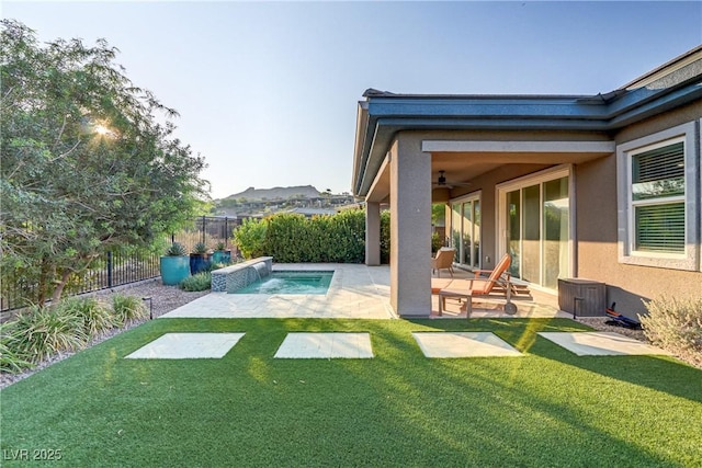 view of yard featuring a fenced backyard, a fenced in pool, a ceiling fan, and a patio