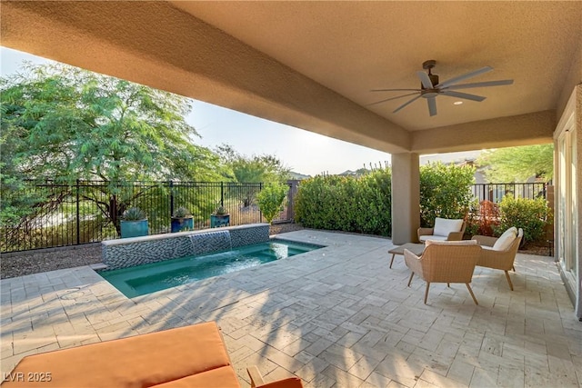 view of pool featuring a patio area, a fenced backyard, and ceiling fan