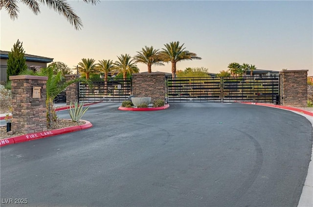 exterior space with a gate, a gated entry, and curbs