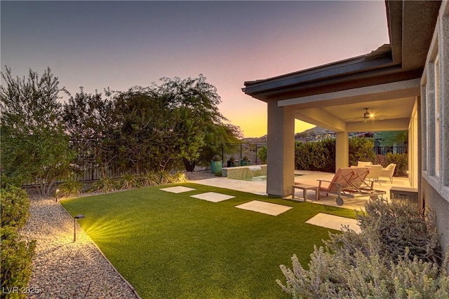 view of yard featuring a ceiling fan, a patio area, and a fenced backyard