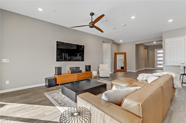 living room with ceiling fan, recessed lighting, wood finished floors, and baseboards