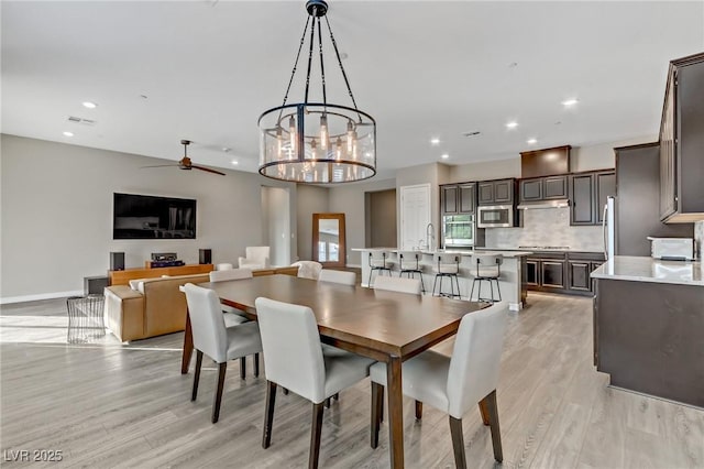 dining space with baseboards, light wood finished floors, visible vents, and recessed lighting