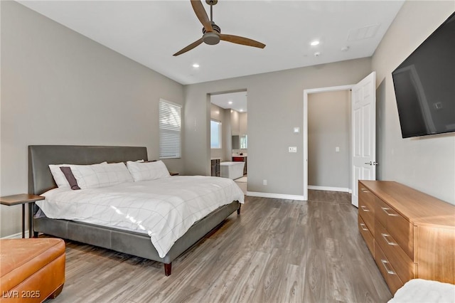 bedroom with baseboards, wood finished floors, and recessed lighting