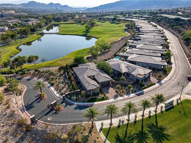 bird's eye view featuring view of golf course and a water and mountain view