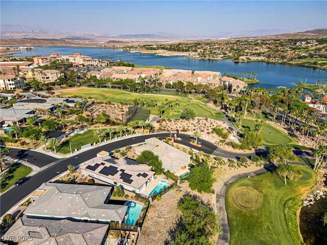 drone / aerial view with golf course view, a water view, and a residential view