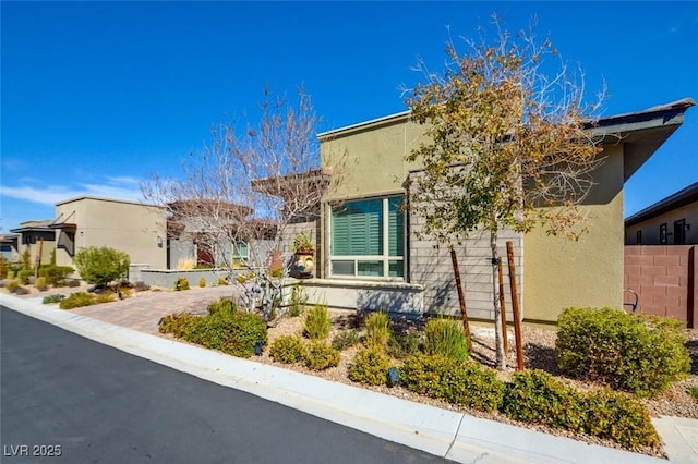 exterior space featuring fence and stucco siding