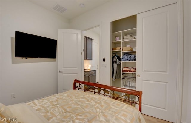 bedroom with a closet and visible vents