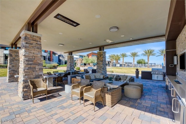 view of patio with outdoor dining space, a grill, and area for grilling