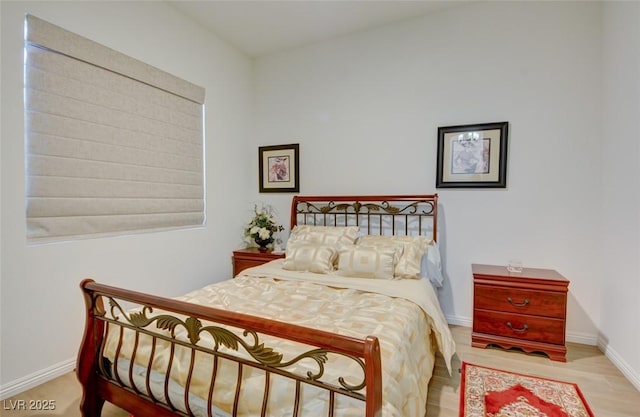 bedroom featuring baseboards and wood finished floors