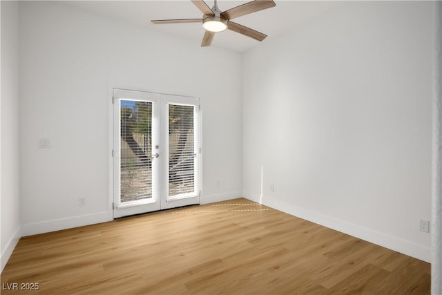 empty room featuring a ceiling fan, light wood-type flooring, french doors, and baseboards