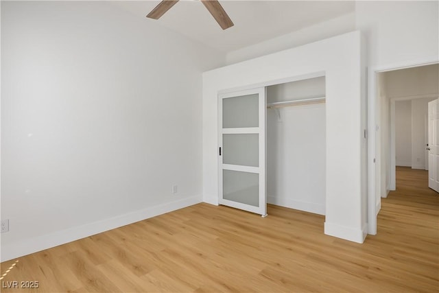 unfurnished bedroom featuring a closet, light wood-style flooring, and baseboards