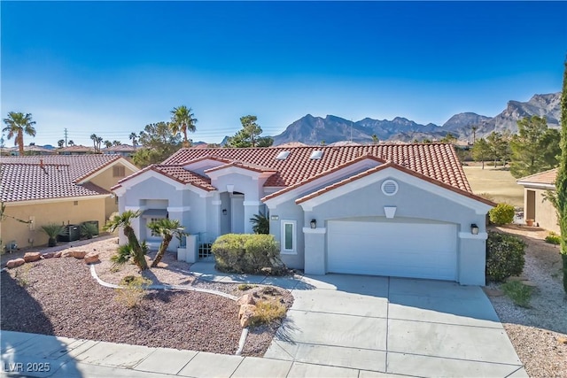 mediterranean / spanish-style home with central AC unit, a garage, a tile roof, concrete driveway, and stucco siding