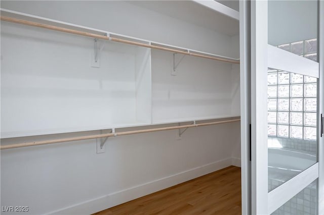 spacious closet featuring wood finished floors