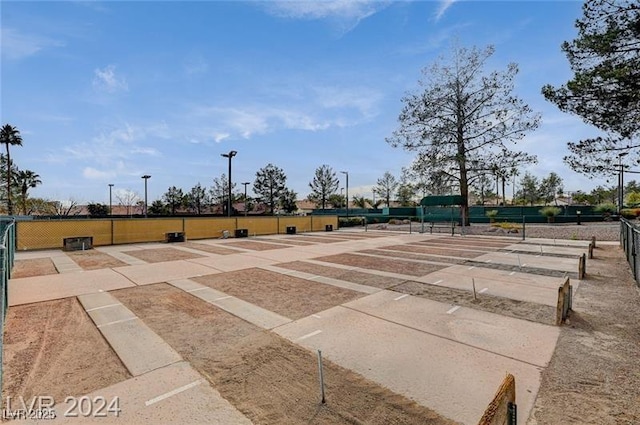 view of home's community featuring fence