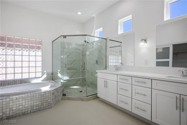 2265 Lauren Dr, Las Vegas, NV 89134 - full bath featuring double vanity, a shower stall, a bath, and tile patterned flooring
