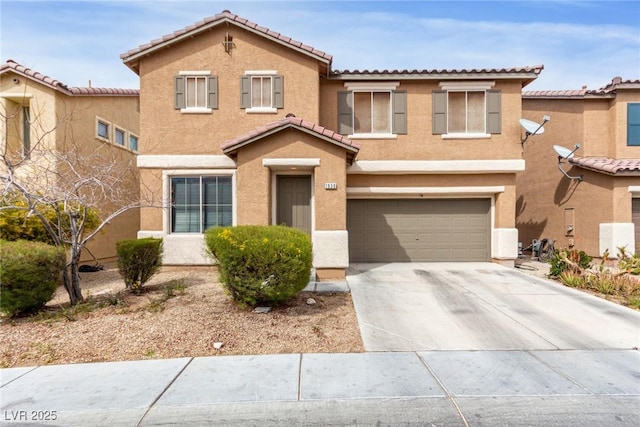 view of front of property featuring concrete driveway, a tiled roof, an attached garage, and stucco siding