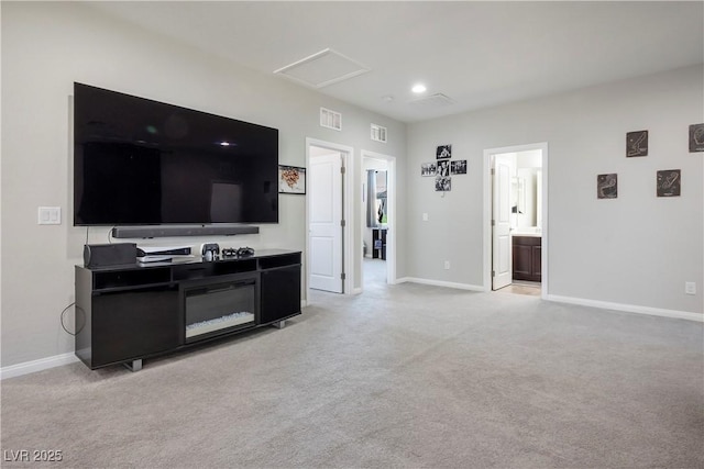 living room featuring attic access, light carpet, and visible vents