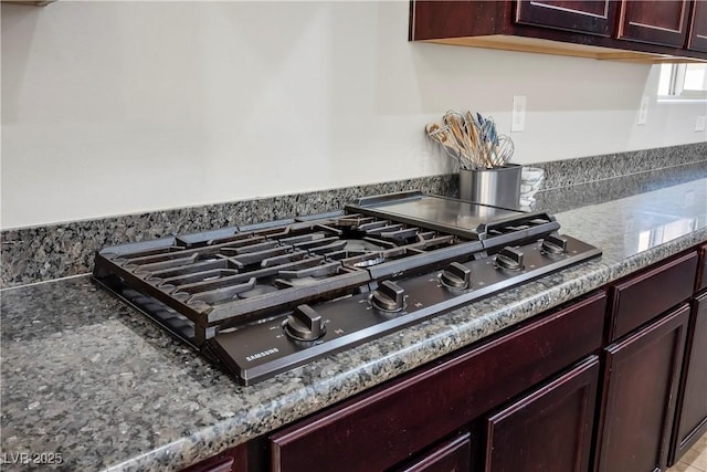 room details with dark brown cabinets and gas stovetop