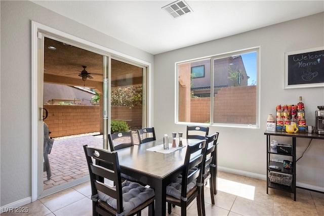 dining area with light tile patterned floors, visible vents, and baseboards