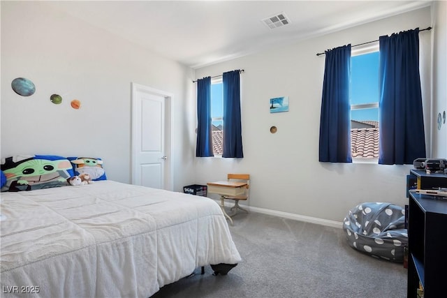 carpeted bedroom featuring baseboards and visible vents