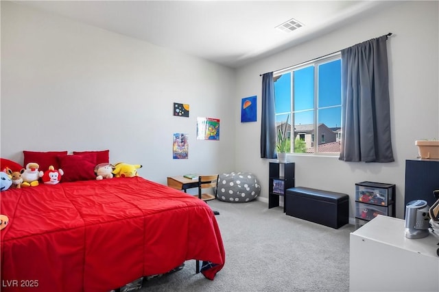 carpeted bedroom with visible vents and baseboards