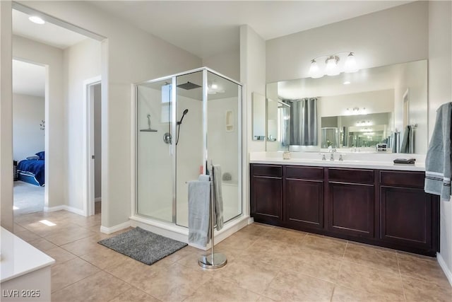 bathroom featuring a stall shower, tile patterned flooring, vanity, and ensuite bath