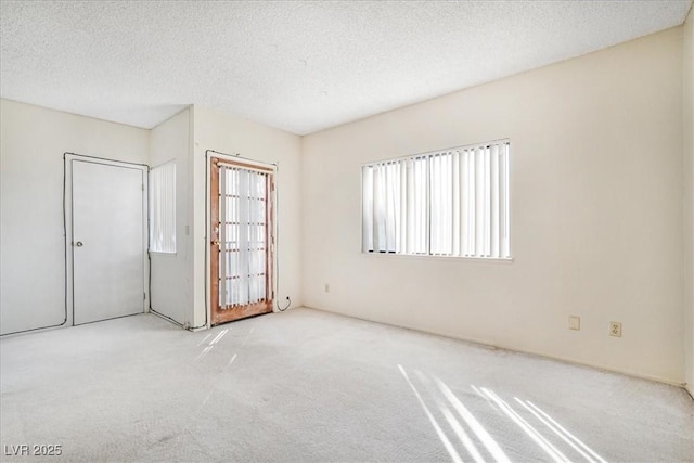 empty room featuring carpet floors and a textured ceiling