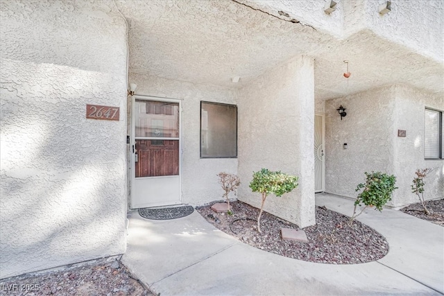 entrance to property with stucco siding