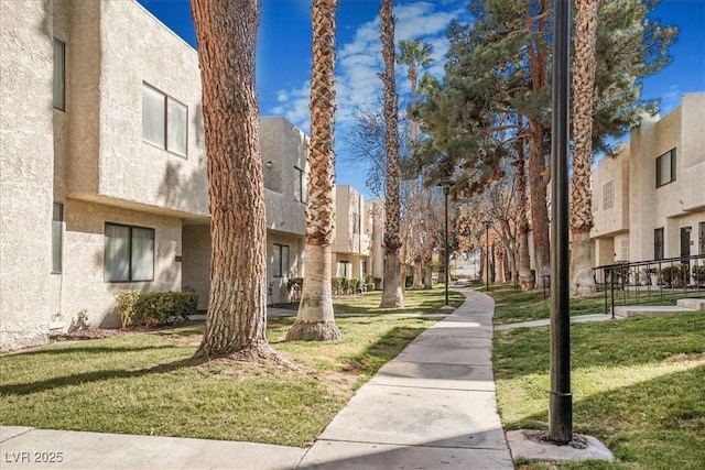 surrounding community with a residential view and a lawn